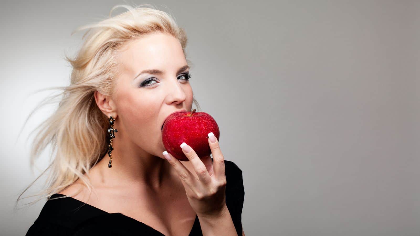 sexy woman eating apple