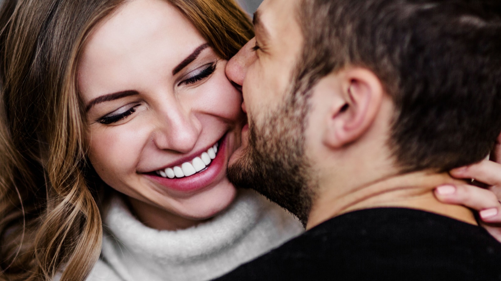 man kissing cheek