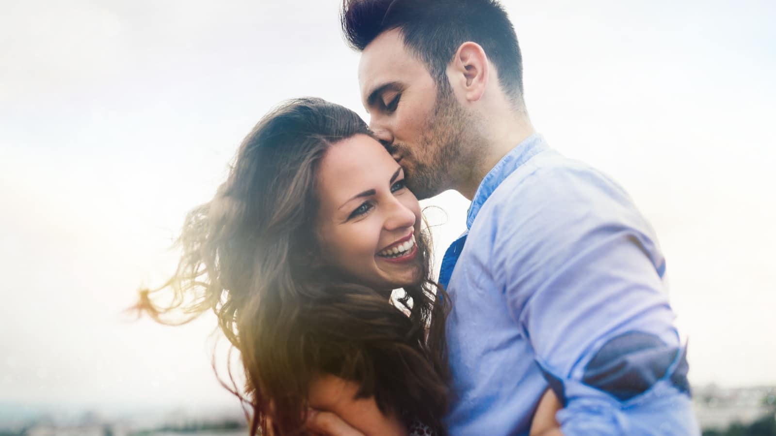 man kissing woman